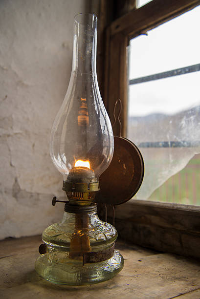 Vintage kerosene lamp at window stock photo