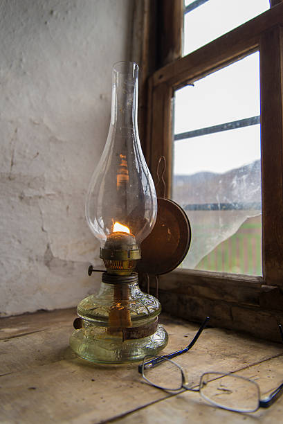 Vintage kerosene lamp at window stock photo