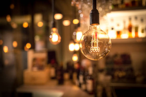 Vintage lamp bulb with bar or cafe night abstract background stock photo