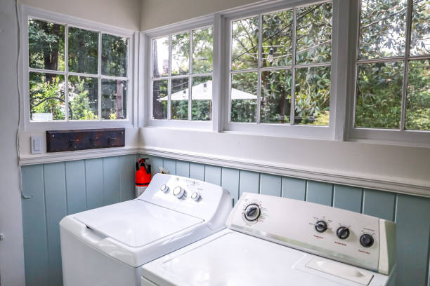 A vintage laundry room filled with windows and natural light stock photo