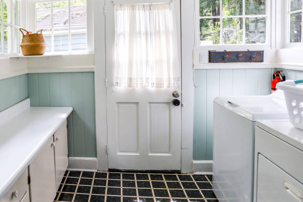 A vintage laundry room filled with windows and natural light stock photo