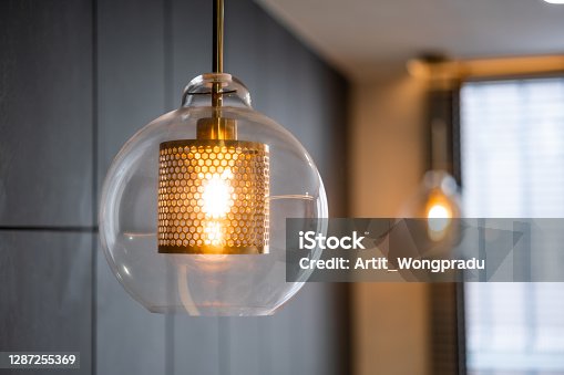 istock Vintage luxury interior lighting lamp cover with bronze plate and transparent glass bulb for home decor. 1287255369