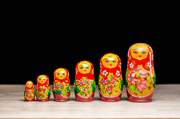 Vintage matryoshka dolls Vintage Russian matryoshka nesting dolls lined on table russian nesting doll stock pictures, royalty-free photos & images