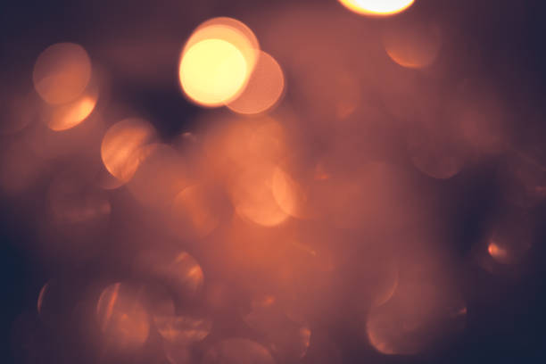 Vintage orange red warm bokeh with sparkling lights in dark orange colors as Christmas background stock photo