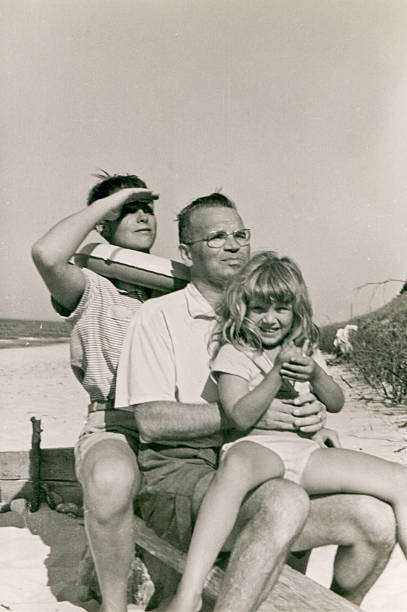 Vintage photo of happy family on beach stock photo