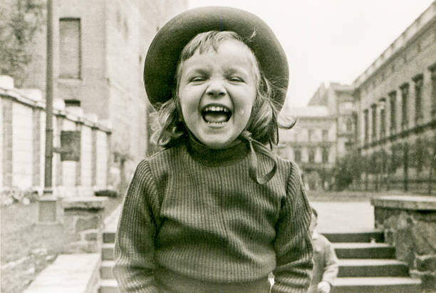 Vintage photo of little girl laughing stock photo