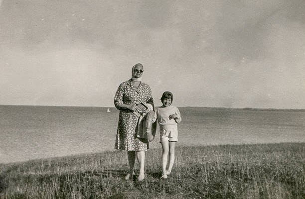 Vintage photo of mother and daughter on beach stock photo