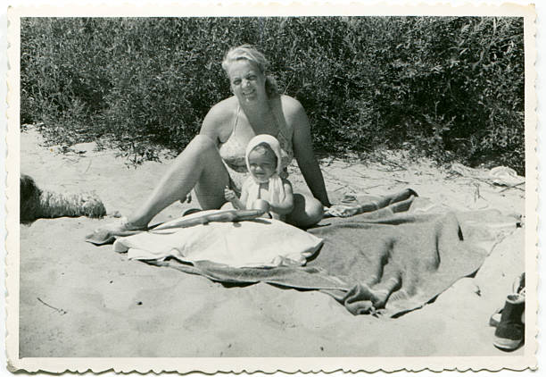 Vintage photo of mother and daughter on beach stock photo