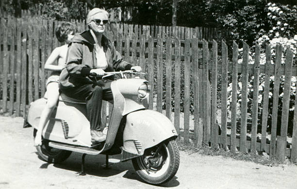 Vintage photo of mother and daughter on scooter stock photo