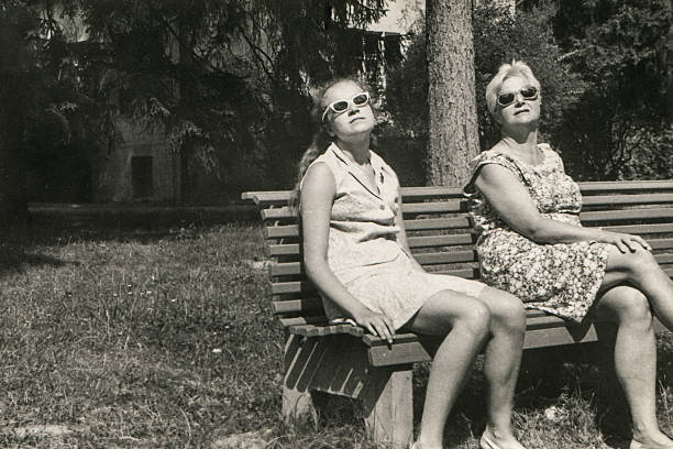 Vintage photo of mother and daughter sunbathing stock photo