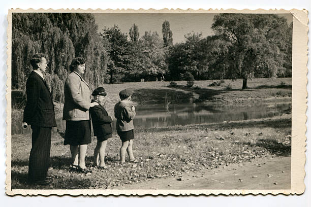 Vintage photo of parents with sons in park stock photo