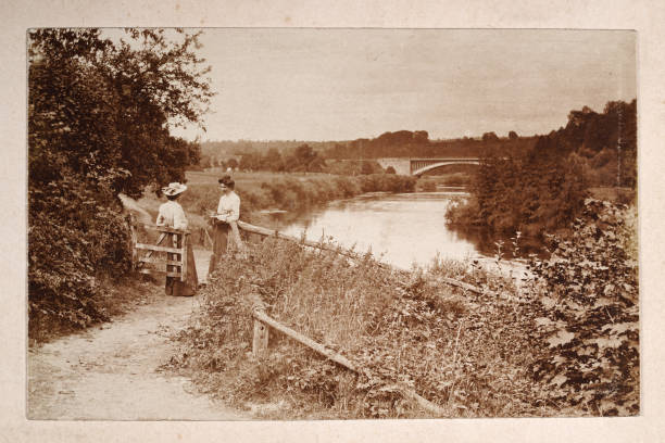 Vintage photograph of two woman talking on country footpath bay a river, Victorian, 19th Century stock photo