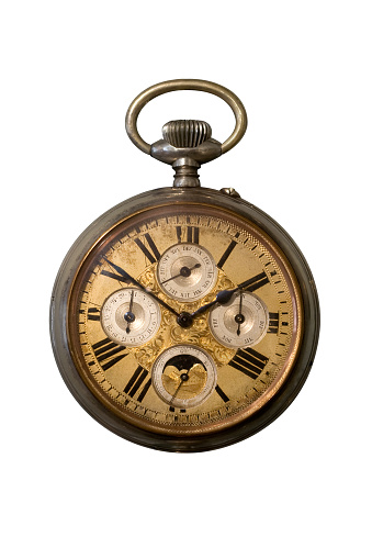 Vintage copper pocket clocks on dark wood background