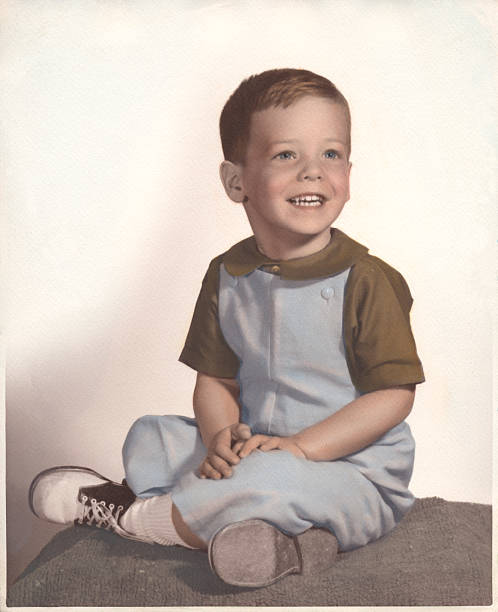 A vintage portrait of a young boy smiling Circa 1964, hand tinted photograph of a 4 year old boy. boys photos stock pictures, royalty-free photos & images