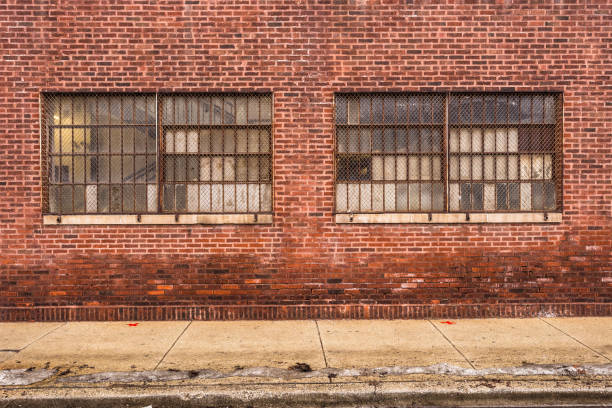 Vintage red brick industrial building with frosted windows in urban Chicago stock photo