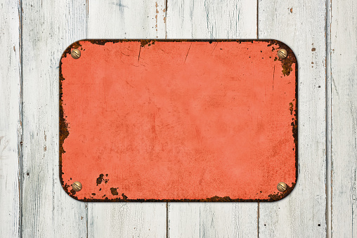 Vintage red tin sign on a wooden background
