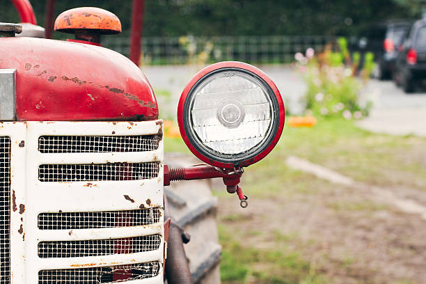 Vintage Red Tractor on Farm with headlight stock photo