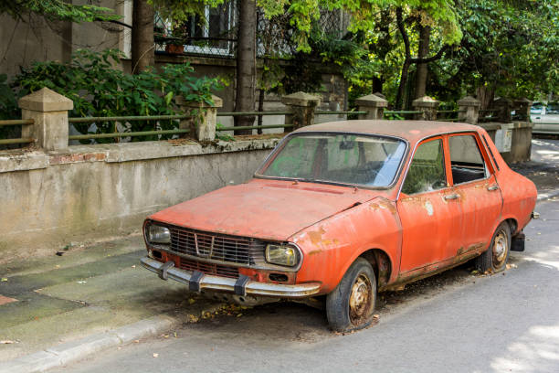 Vintage Romanian car Abandoned red vintage Romanian Dacia 1300 with flat tires obsolete stock pictures, royalty-free photos & images