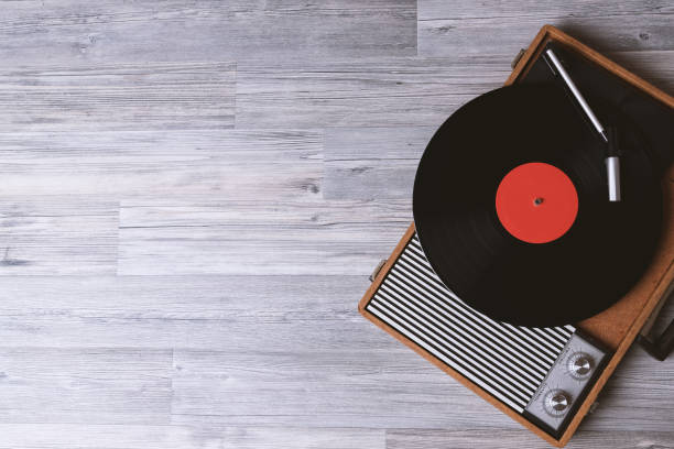 Vintage Sound technology for DJ Turntable vinyl record player on the background of their gray wooden boards. Needle on a vinyl record. Black vinyl record,Sound technology for DJ to mix & play music. turntable stock pictures, royalty-free photos & images