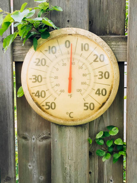 Vintage Thermometer On An Old Wooden Fence stock photo