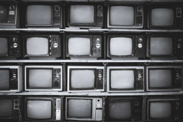 vintage tv Pattern wall of pile black and white retro television (TV) - vintage filter effect style. television industry photos stock pictures, royalty-free photos & images