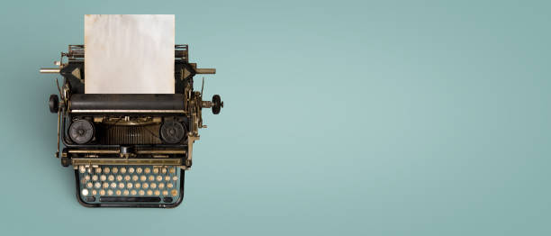 Vintage typewriter header Vintage typewriter header with old paper. retro machine technology - top view and creative flat lay design. typewriter stock pictures, royalty-free photos & images