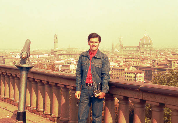 Vintage visit to Florence Vintage image from the seventies featuring a man looking at camera with a panoramic view of Florence , Italy in the background. italy photos stock pictures, royalty-free photos & images