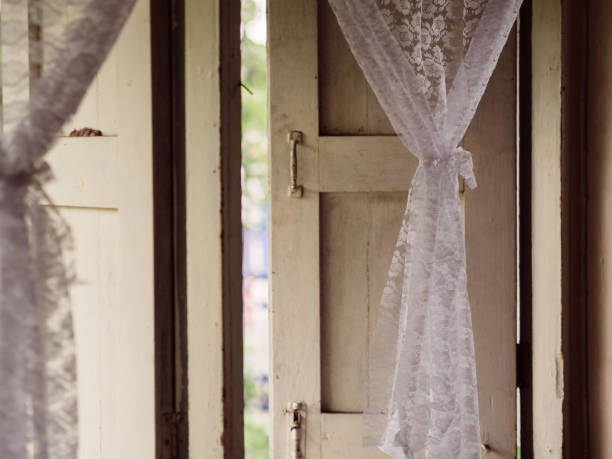 Vintage white curtains on soft light window. stock photo