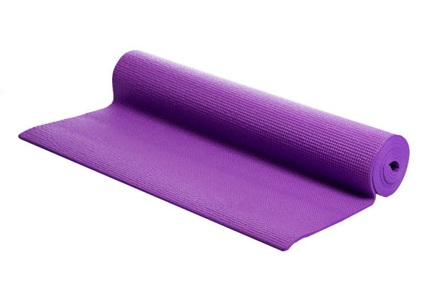 violet yoga mat on a white background stock photo
