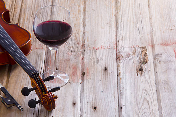 Violin and Wine on Wooden Floor with Copy Space stock photo
