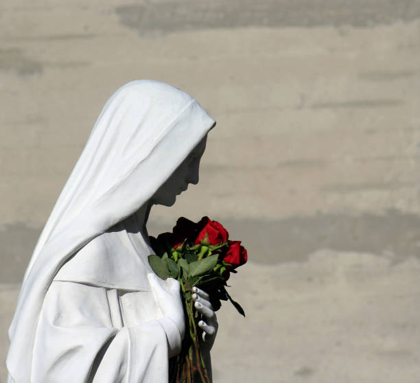Virgin Mary holding roses stock photo