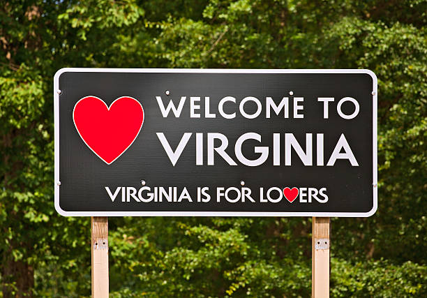 Virginia is for Lovers, state motto and welcome sign Virginia is for Lovers, state motto and welcome sign on a billboard surrounded by trees virginia us state stock pictures, royalty-free photos & images