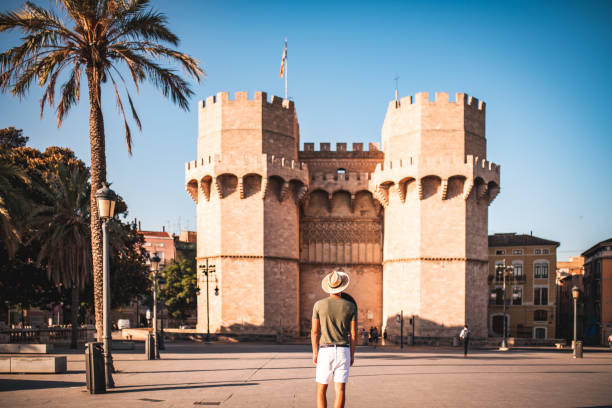 Visiting Spain Male traveler visiting Valencia.He is catching early morning sun to enjoy the city comunidad autonoma de valencia stock pictures, royalty-free photos & images