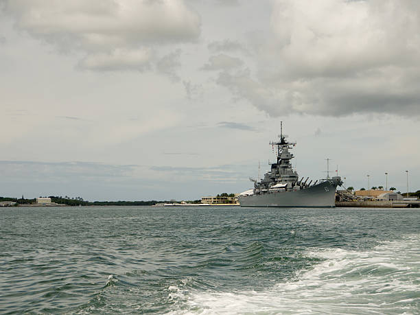 Visiting USS Missouri in Pearl Harbor Bow of USS Missouri. USS Arizona memorial in foreground. Control tower in background. pearl harbor stock pictures, royalty-free photos & images