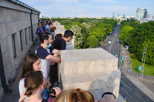 Visitors on the upper terrace of the Arch of Triumph in Bucharest, Romania. stock photo