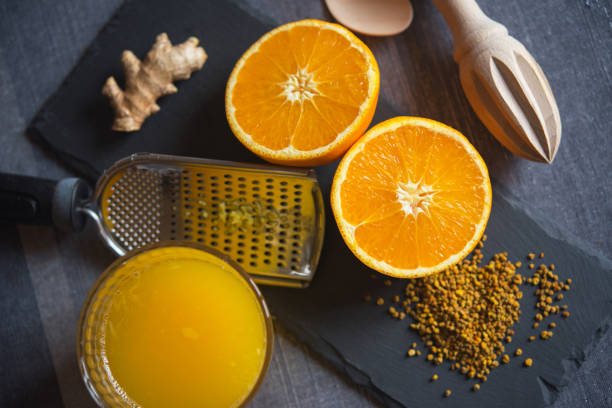Vitamin Orange Juice with Edible Pollen and Ginger stock photo