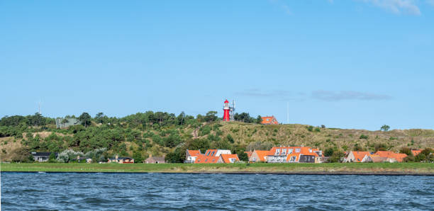 Vlieland with Vuurduin lighthouse on vuurboetsduin and East-Vlieland town from Waddensea, Friesland, Netherlands stock photo