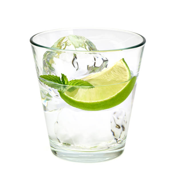 Vodka in rocks glass isolated on white background Vodka with ice and lime wedge isolated on white background vodka soda stock pictures, royalty-free photos & images