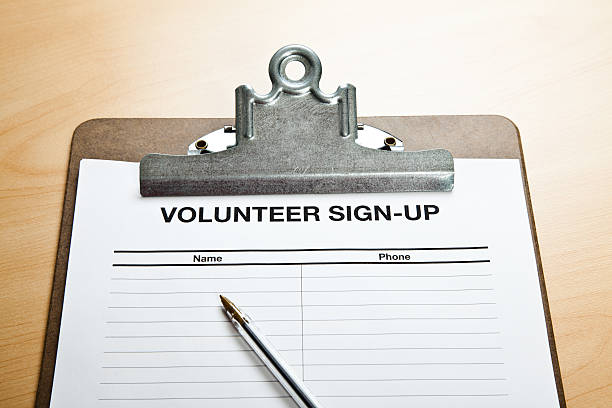 Volunteer Sign-Up Blank volunteer sign-up sheet on a clipboard waiting for people to put their name and phone down to volunteer. With pen. signup stock pictures, royalty-free photos & images