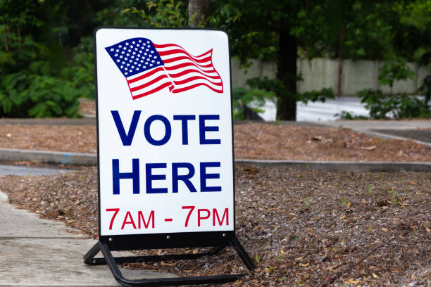 Vote here sign outside an election site. Vote here sign for polling location to vote for elected government officials. polling place stock pictures, royalty-free photos & images