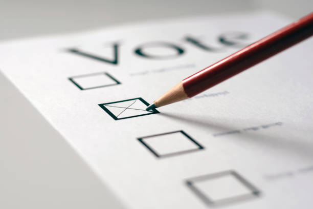 Vote This is a voting card marked with an x in the second box with a pencil.  The focus is on the pencil tip. voting ballot photos stock pictures, royalty-free photos & images