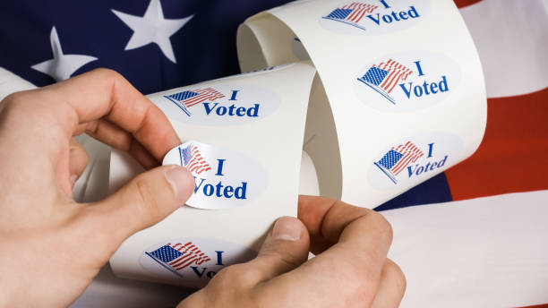I voted sticker with usa flag I voted stickers with united states flag with human hands voting photos stock pictures, royalty-free photos & images