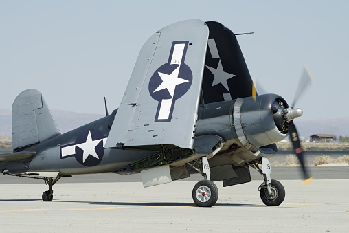 Lancaster, California, USA - March 24, 2018: Image of Chance Vought F4U-1 Corsair with registration NX83782 shown on the apron with folded wings and running engine. The F4U-1 is an American fighter aircraft which saw service primarily in World War II and the Korean War.