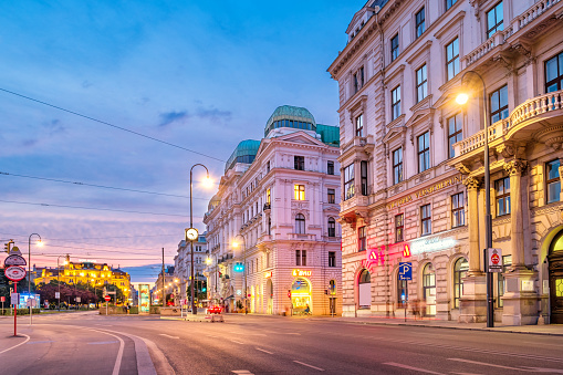 Wahringer Strasse at Schottentor in downtown Vienna Austria illuminated in the evening. Wahringer Strasse is one of the main arterial streets of Vienna.