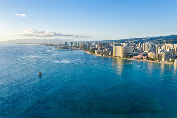 Waikiki Beach Honolulu Hawaii with Ocean The beach, hotels, office towers and commercial buildings in Honolulu Hawaii. honolulu stock pictures, royalty-free photos & images