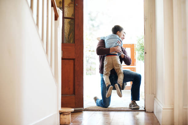 I waited all day to see my little boy Shot of a little boy running into his father's arms as he arrives at home returning home stock pictures, royalty-free photos & images