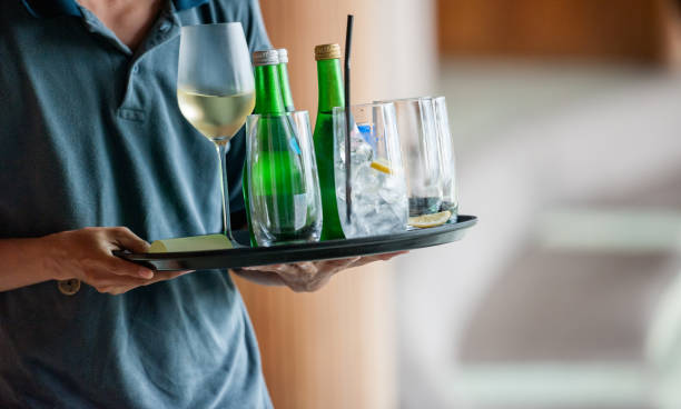 Waiter serves drinks Unrecognizable wait staff serves drinks sparkling water stock pictures, royalty-free photos & images