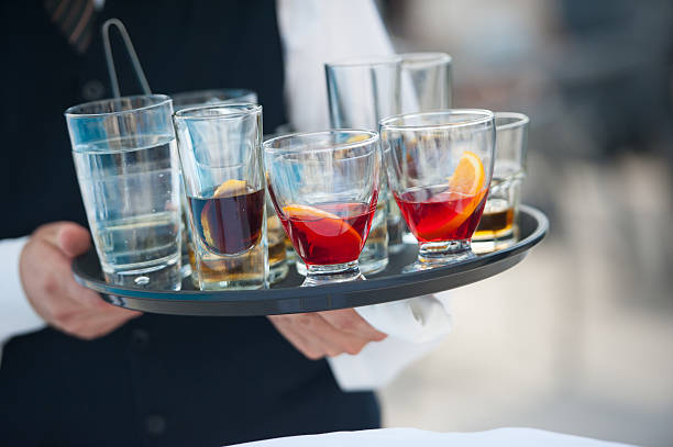 Waiter serving alcohol stock photo