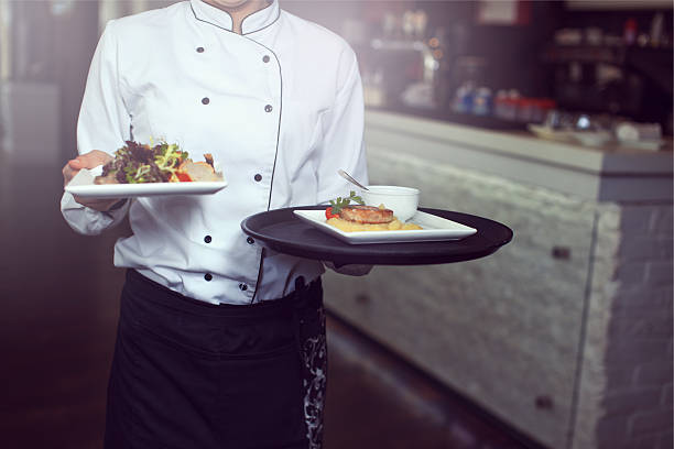 Waiters carrying plates with stock photo