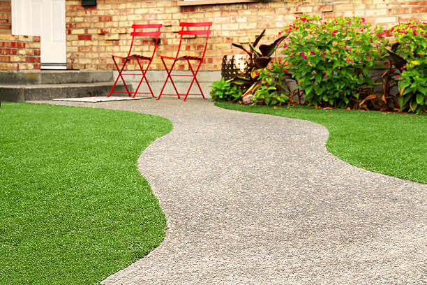 Walk way with perfect grass landscaping with artificial grass in residential area Walk way with perfect grass landscaping with artificial grass in residential area imitation stock pictures, royalty-free photos & images